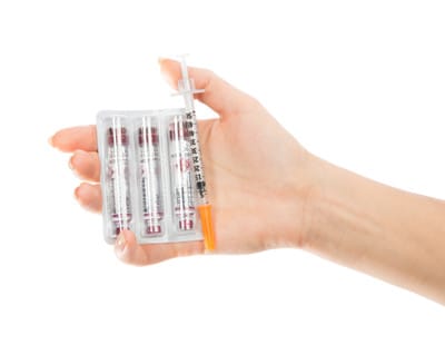 image hand holding insulin needles