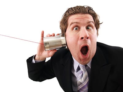 image man holds phone can to ear