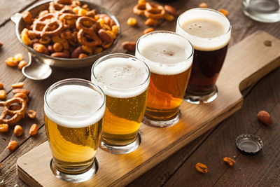 image four beers on a table with snacks